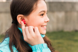 The picture of a girl wearing a hearing aid in Cambodia