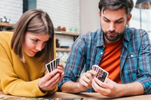 A Group of Players Using Strategies to Play Cards